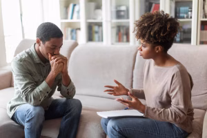 frustrated-african-american-man-sitting-couch-psychotherapist-office