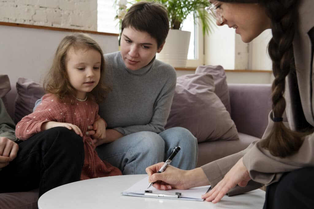 a parent and her daughter talking to a psychologist, parent guidance massachusetts