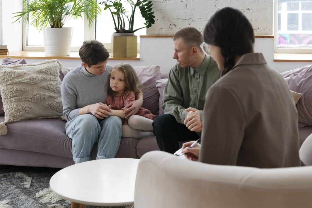 Parents and kid doing therapy in a Parenting consultation in Massachusetts