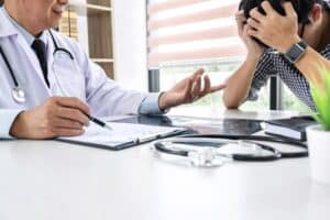 psychopharmacologist-explaining-tensed-patient-about-his-medication-after-session