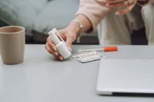 Sick woman with headache sitting at home, psychiatrist vs therapist