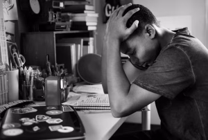 teenage-boy-bedroom-doing-work-stressed-out-frustrated