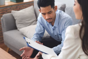 woman-psychiatrist-talking-with-asian-young-man-patient-about-his-illness