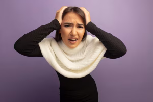 Distressed young woman with a white scarf experiencing a panic attack