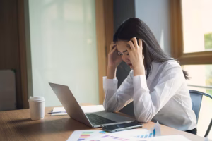 Girl with stress leaning on a table, psychiatric evaluation in massachusetts