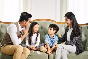 asian-parents-two-children-chatting-home