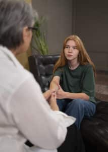 Authentic scene of young person undergoing psychological therapy, psychiatrist appointment boston