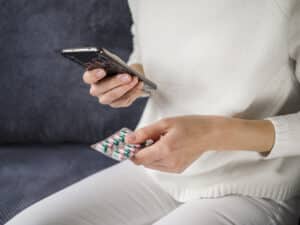 Close-up patient holding pills, psychopharmacology massachusetts