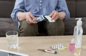 Front view of elder woman taking her pills, psychopharmacology for depression in massachusetts
