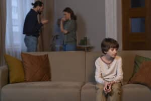 a child suffering from parents arguing behind him, parenting counseling Massachusetts