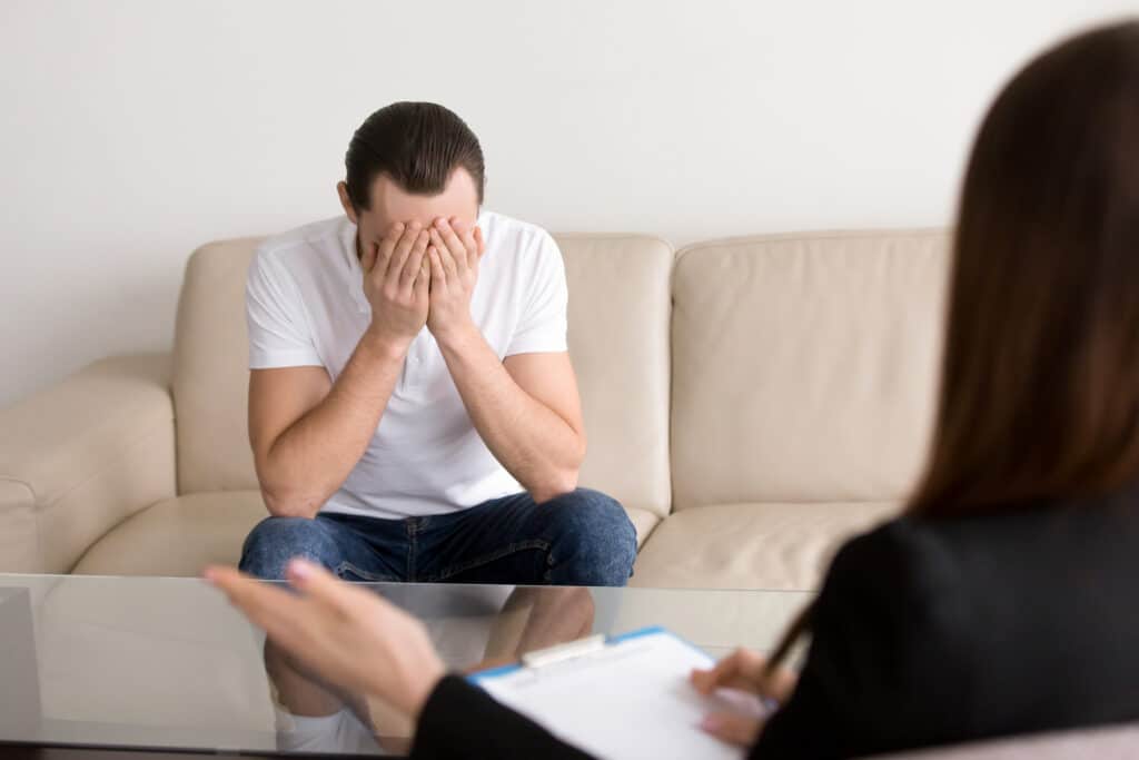 Depressed man in therapy session feeling hopeless with ocd psychiatrist tremont street and park street boston