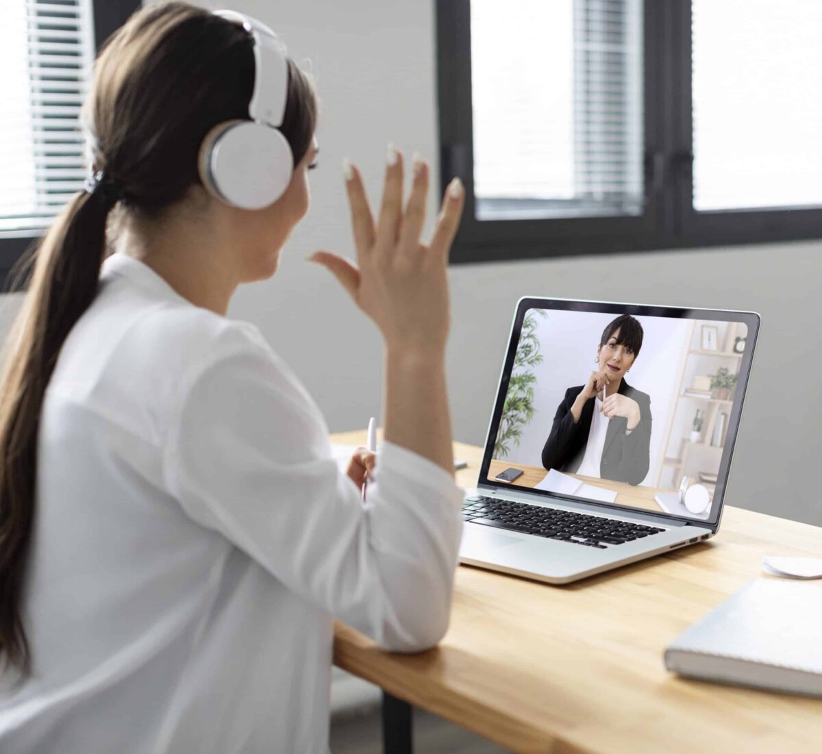 Smiley woman attending a video call during a Telepsychiatry MA appointment from home
