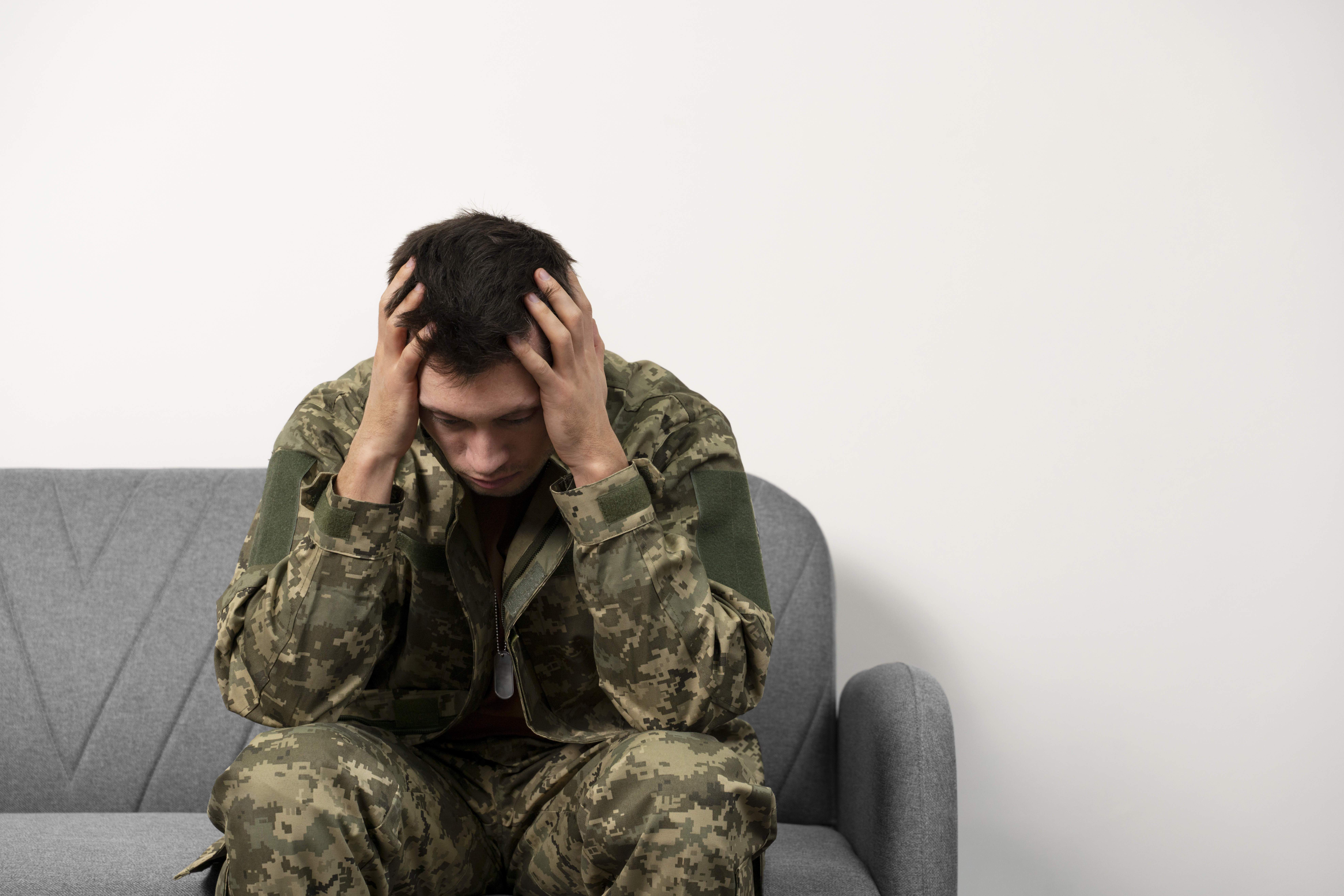 Young soldier coping with trauma during therapy session, consulting a ptsd psychiatrist northern avenue and harbor shore drive boston