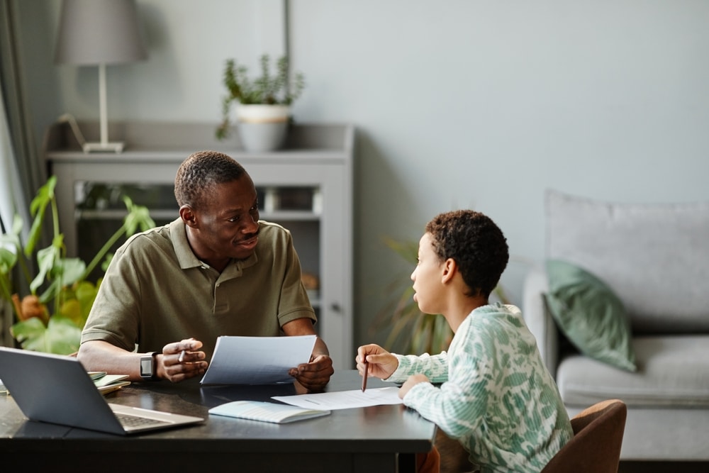 Emotionally intense teens Massachusetts – father helping teen study at home