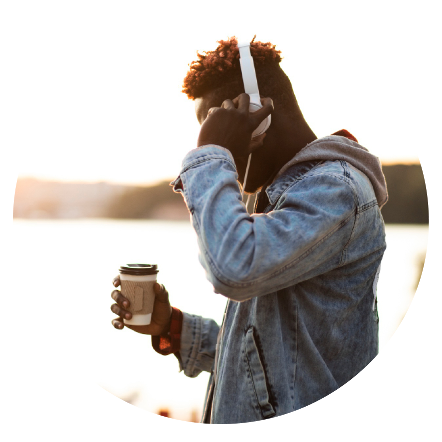 Boston Premier Psychiatry Side view guy with headphones and coffee cup Wellesley Massachusetts