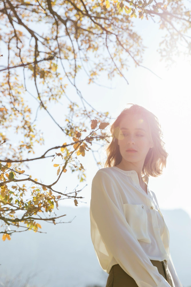 person near plants in sunlight calm emotional recovery